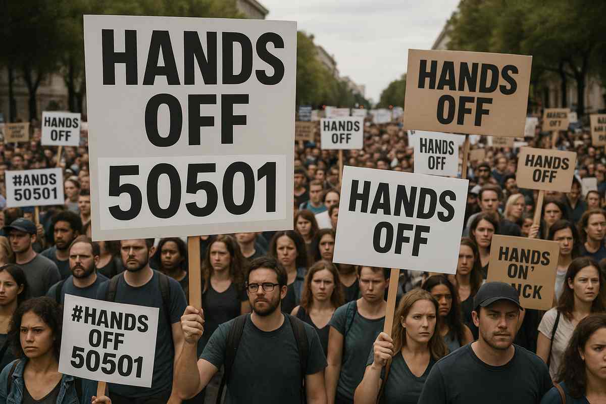 Protesters holding signs with messages like 'Hands Off' during a demonstration"