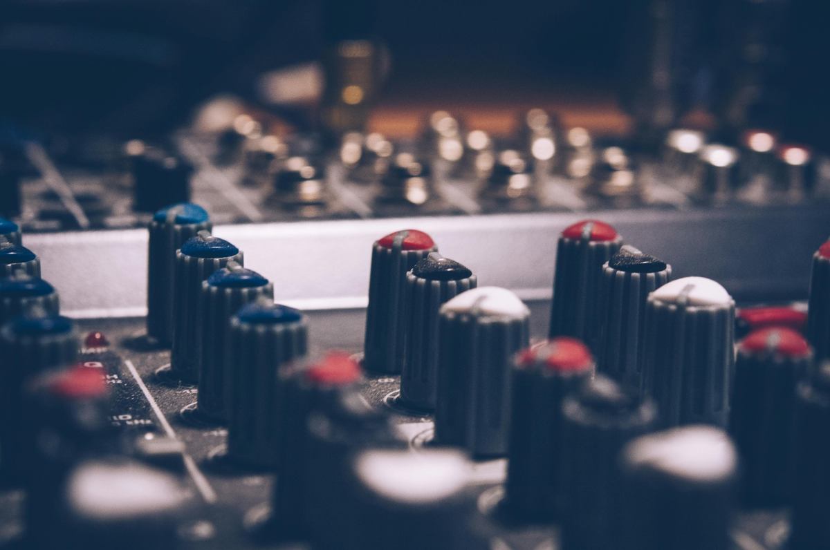 "Close-up of audio mixer control knobs in a recording studio"