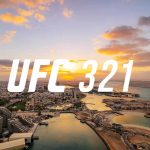Aerial view of Abu Dhabi’s waterfront at sunset with bold white “UFC 321” text centered across the skyline.