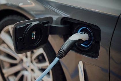 Close-up view of an electric car being charged, symbolizing the growth of the global EV market and clean transportation trends.