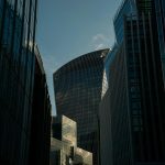 “Modern glass skyscrapers reflecting sunlight in a financial district skyline”