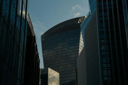 “Modern glass skyscrapers reflecting sunlight in a financial district skyline”