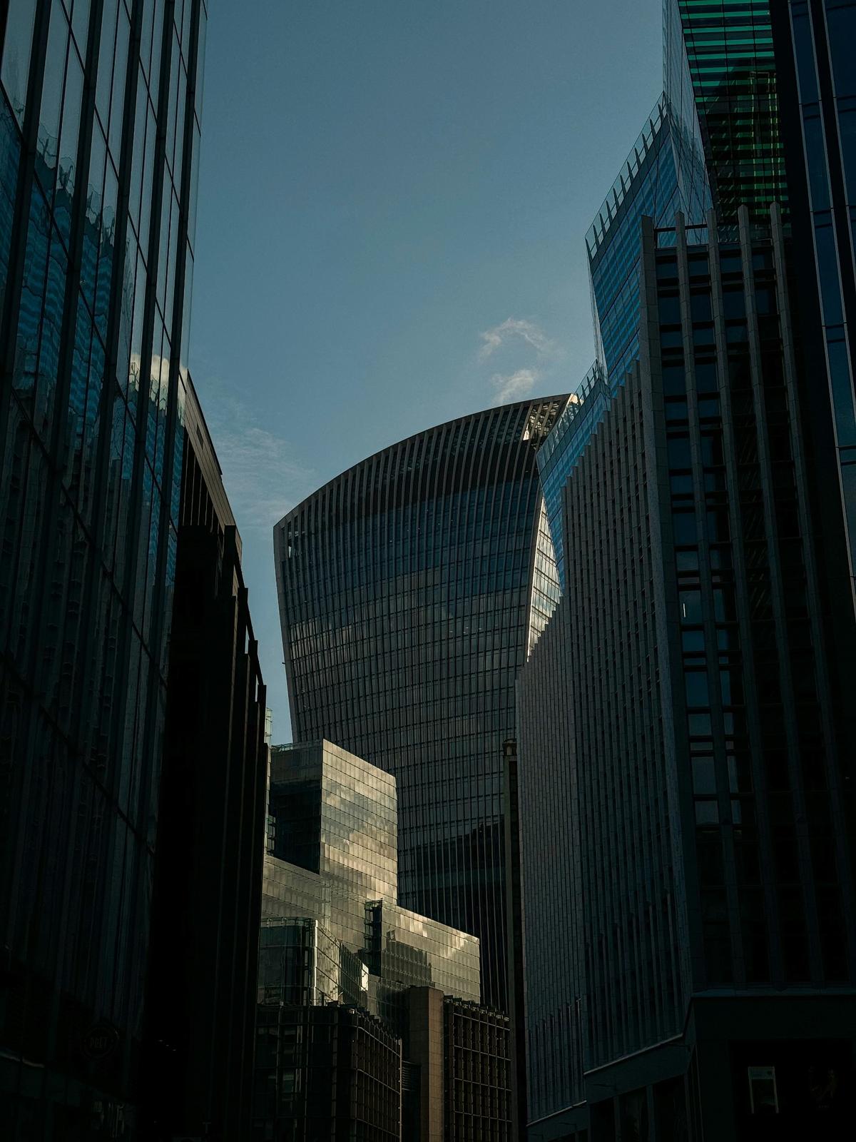 “Modern glass skyscrapers reflecting sunlight in a financial district skyline”