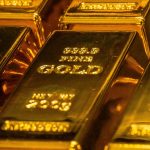 Stacks of gleaming gold bars symbolizing record-high gold prices and investor confidence in safe-haven assets.