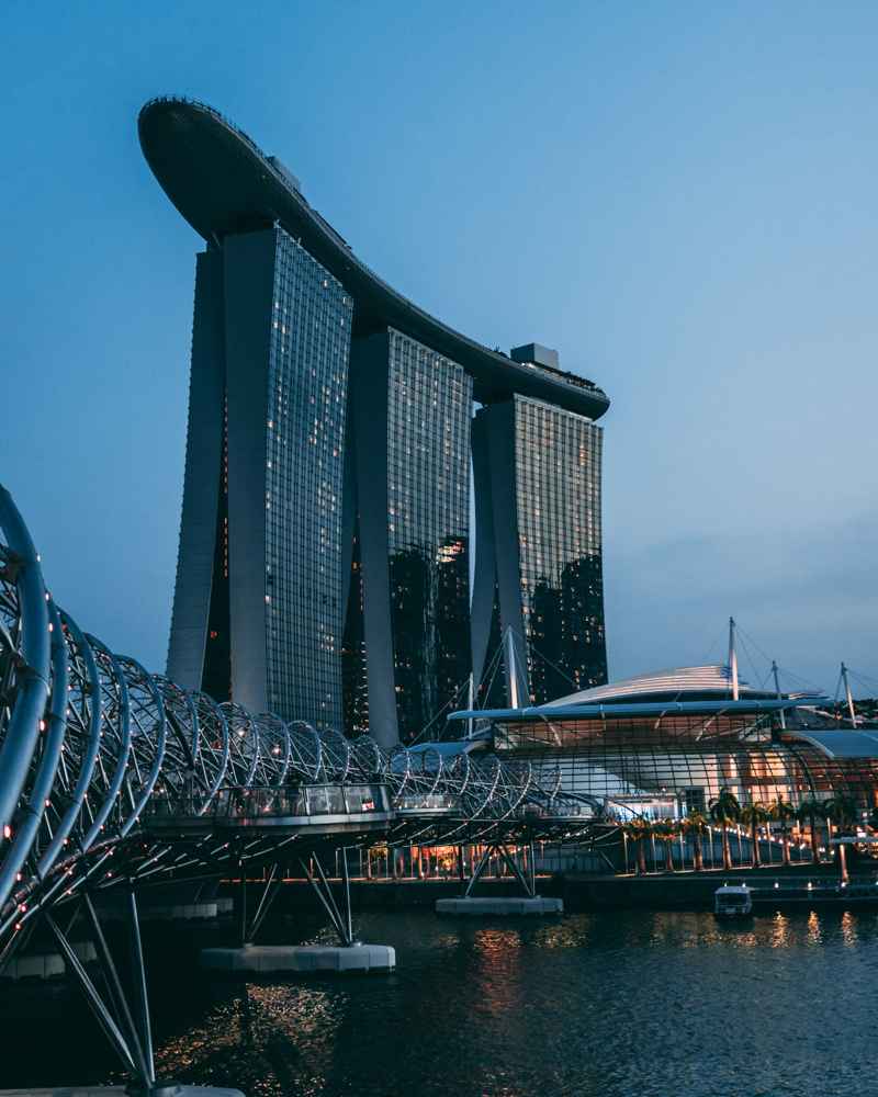 Marina Bay Sands and Helix Bridge illuminated at dusk in Singapore